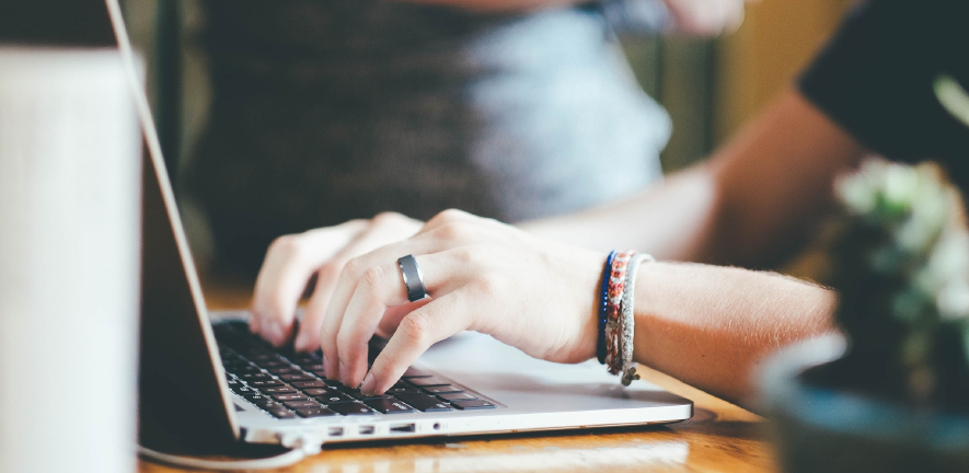 hands typing on laptop